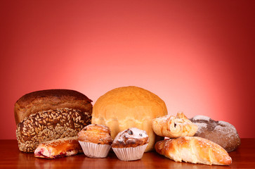 Fresh wheat bread on red background