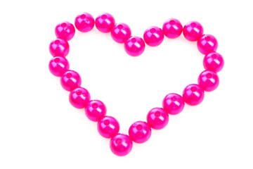 Heart from pink beads isolated on white background