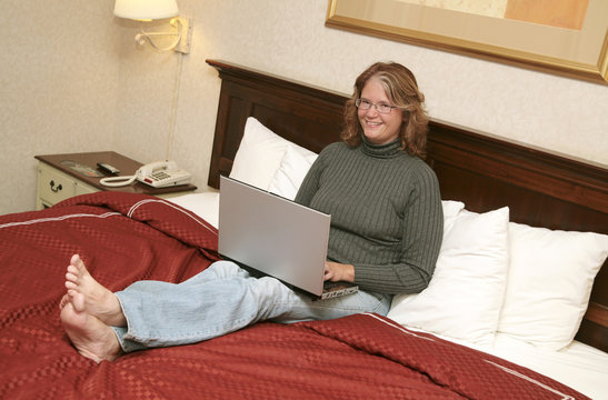 woman on laptop in bed