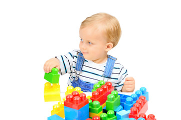 Cute little boy is playing with building blocks