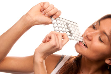Obraz premium Woman bite the pack of medicine aspirin tablets