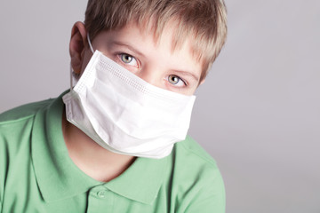 Adorable boy in a protective mask