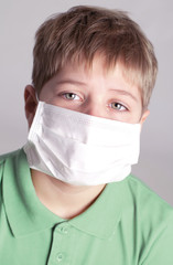 Cute sick boy in a in a mask