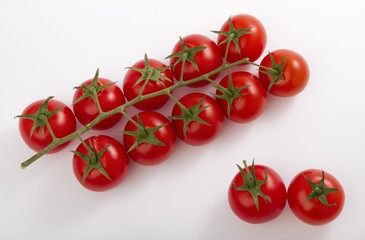 ripe cherry tomatoes on a branch