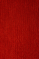 Vertical closeup of seamless red knitted fabric texture