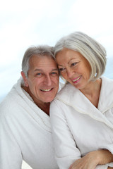Portrait of happy senior couple in spa center - obrazy, fototapety, plakaty