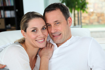 Fototapeta premium Portrait of couple relaxing at home in sofa
