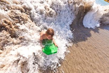 Fototapeta premium young boy surfes in huge waves