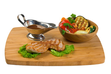 Grilled meat with tomato sauce and vegetables