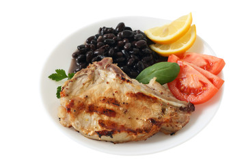 grilled pork with beans, tomato and lemon
