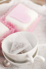 small tea cups and heart pink cupcakes,