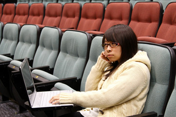 Asian girl studying hard with laptop in university