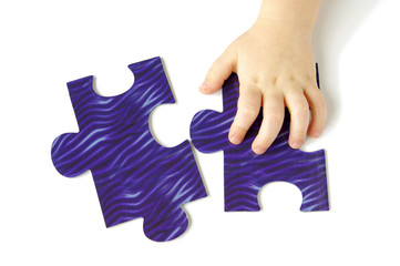 Hhild hands with puzzle