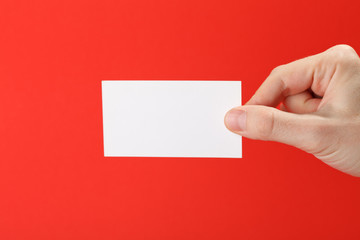 Obraz premium businessman's hand holding blank white paper business card