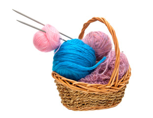 Fototapeta na wymiar Yarn for knitting with knitting needles in a wicker basket