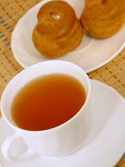 Brewing delicious cake with cream and a cup of tea