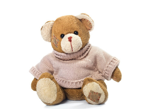 a brown teddy bear with patch on a head sited on white