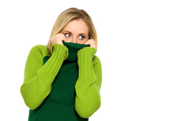 Woman pulling sweater over face