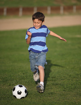 Latino Boy Playing With Soccer Ball