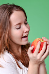 Beautiful woman with red juicy apple