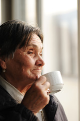 Portrait of Senior Woman Looking Through Window