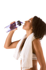 Sporty woman with bottle of water and towel