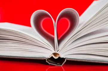 pages of a book curved into a heart shape