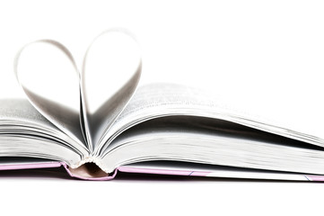 pages of a book curved into a heart shape