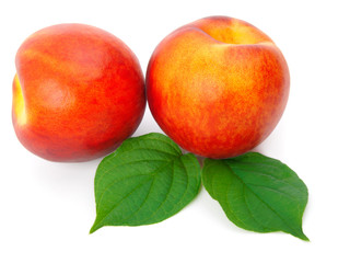 Ripe peach with leaves on a white background