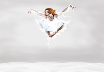 Jump of ballerina with dress of milk