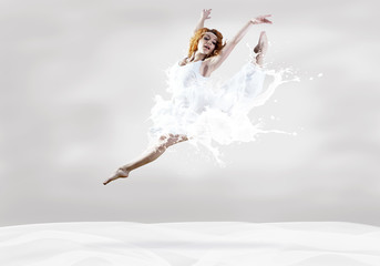 Jump of ballerina with dress of milk