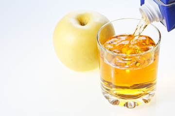 Yellow apple and glass of juice