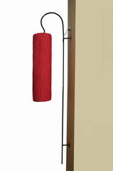 Red fabric long lamp with cream wall