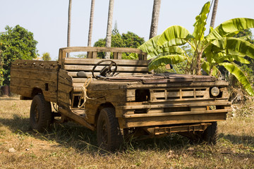 Old wooden car in the jungle . Thailand .