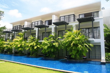 House , blue swimming pool and grass field in thai