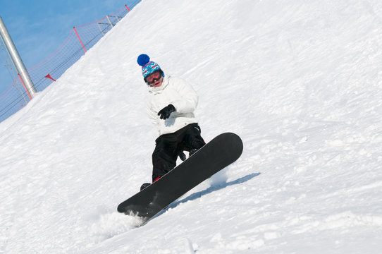 falling young man on snowboard at snowy winter