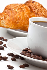 Breakfast: coffee and croissant with sesame seeds