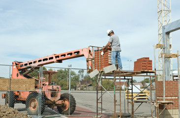 Worker Unloading Brick