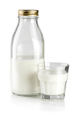 Glass of milk and bottle on white background
