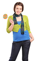 A happy young girl holding a lollypop