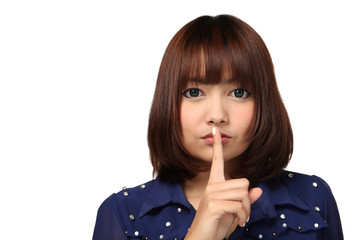 Naklejka premium Young Thai girl with her finger over her mouth