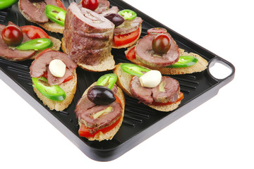 black teflon grill plate with meaty tartlets