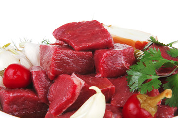 meat chunks on white bowls with vegetables