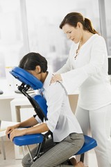 Businesswoman getting neck massage