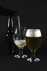 Pouring beer in glass.