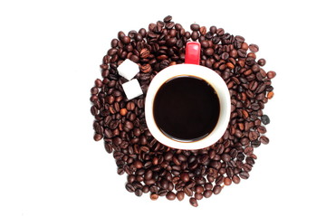 Red mug of coffee with roasted coffee beans and sugar lumps