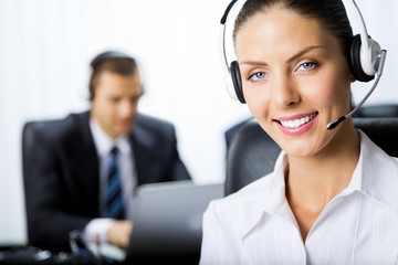 Two support phone operators at workplace