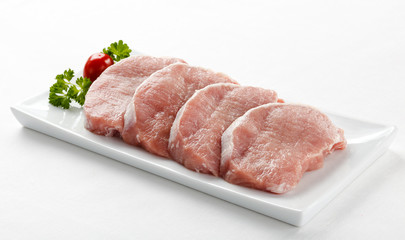 Fresh raw pork on white plate