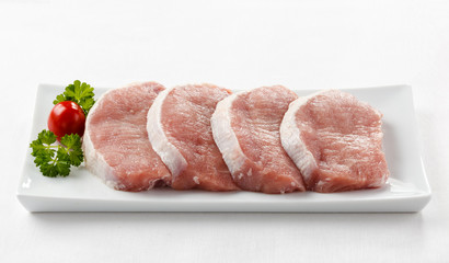Fresh raw pork on white plate