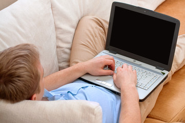 Fototapeta premium young man using a laptop at home